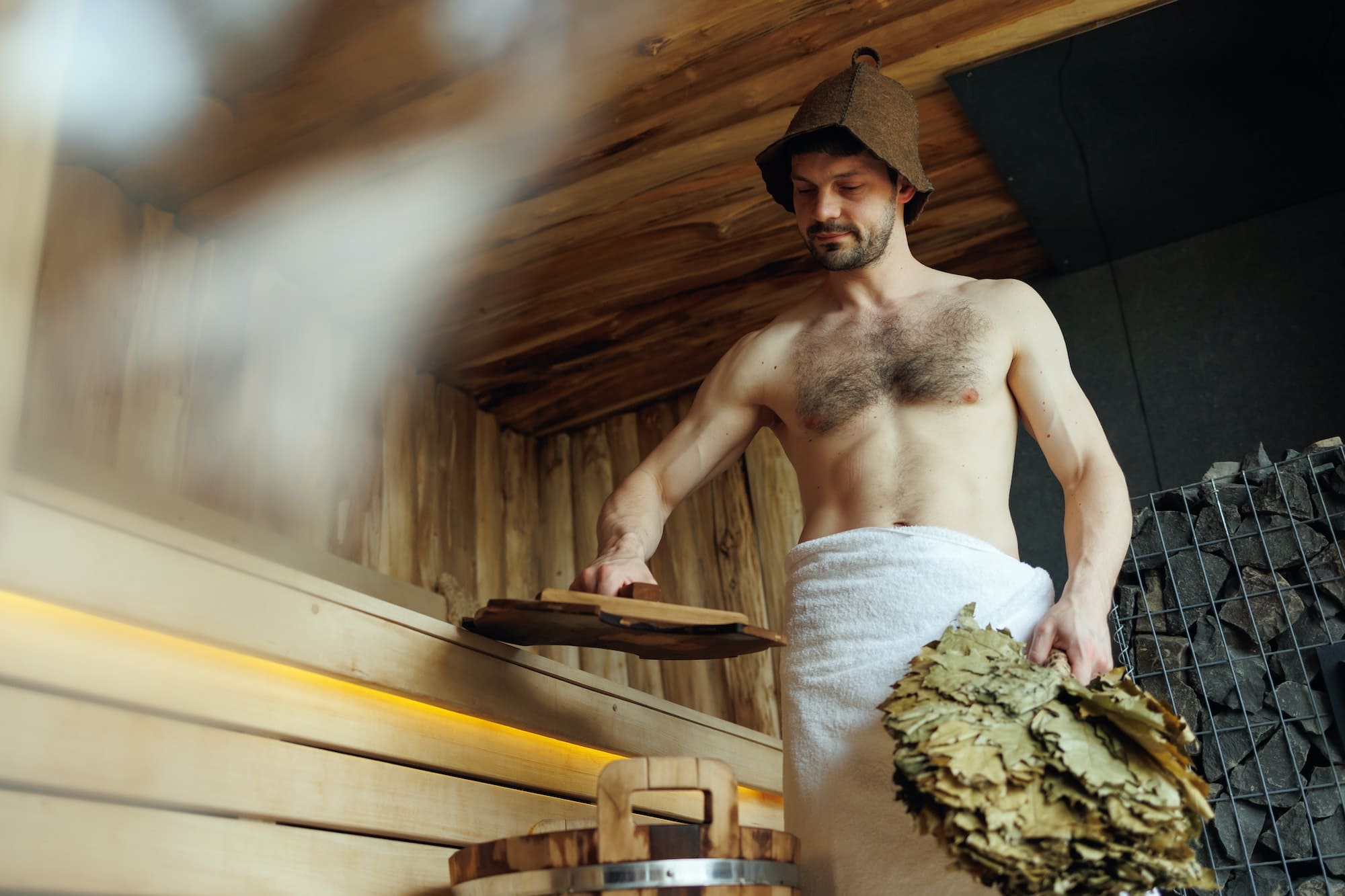 Man relaxing in sauna during vacation at spa resort